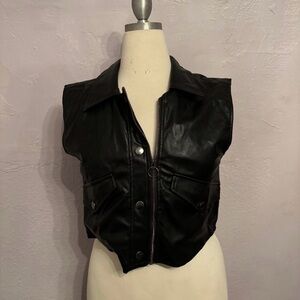 Woman’s black zip up vest